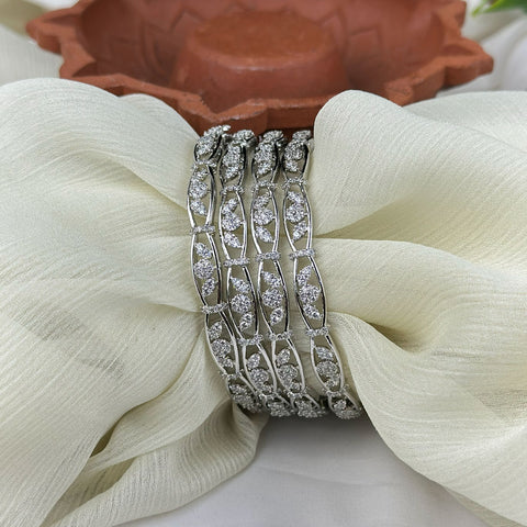 Silver bracelet with clear stones on a white fabric background