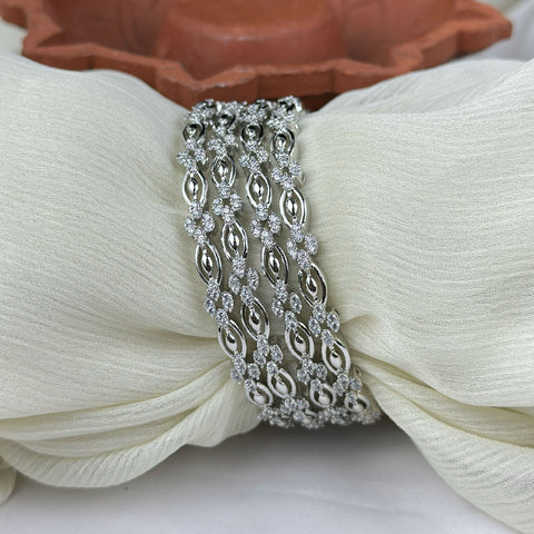 Silver bracelet on a white fabric background