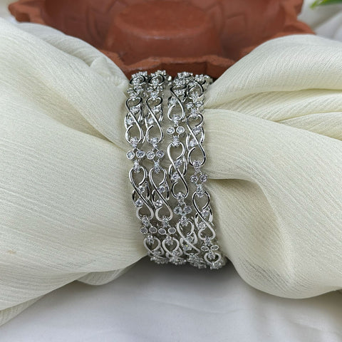 Silver bracelet with clear stones on a white fabric background