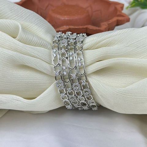 Silver bracelet with clear stones on a white fabric background