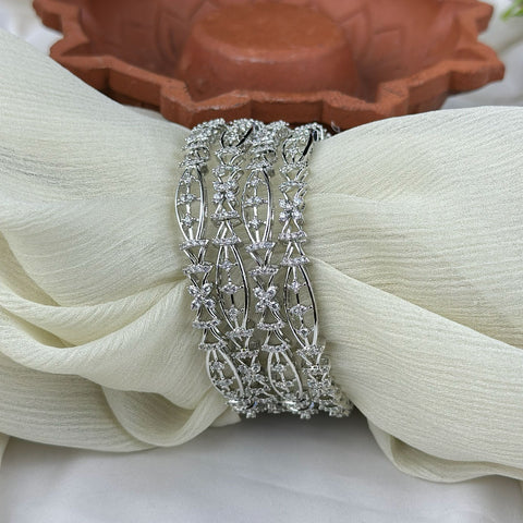 Silver bracelet on a white fabric with a terracotta pot in the background