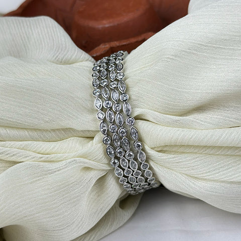 Silver bracelet on a white fabric background