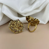 Gold earrings with intricate designs on a white fabric background