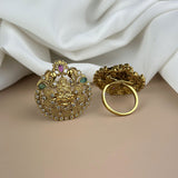 Gold earrings with intricate designs on a white fabric background