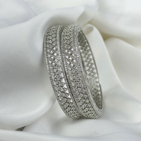 Silver bracelet with gemstones on a white fabric background
