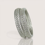 Silver bracelet with embedded stones on a light gray background