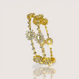 Gold earrings with gemstones on a light beige background