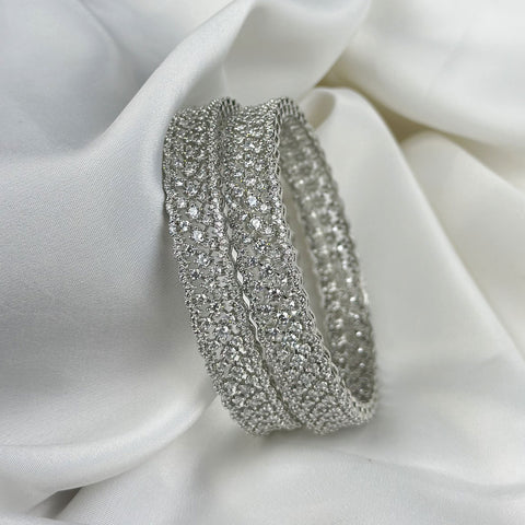 Silver bracelet with clear stones on a white fabric background