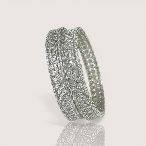 Silver hoop earrings on a light gray background