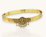 Gold belt with intricate designs and gemstones on a white background