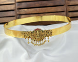 Gold belt with intricate design on a white fabric background