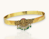 Gold belt with intricate design and green gemstones on a white background