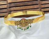 Gold belt with decorative clasp on a white fabric background