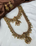 Gold necklace and earrings on a white surface