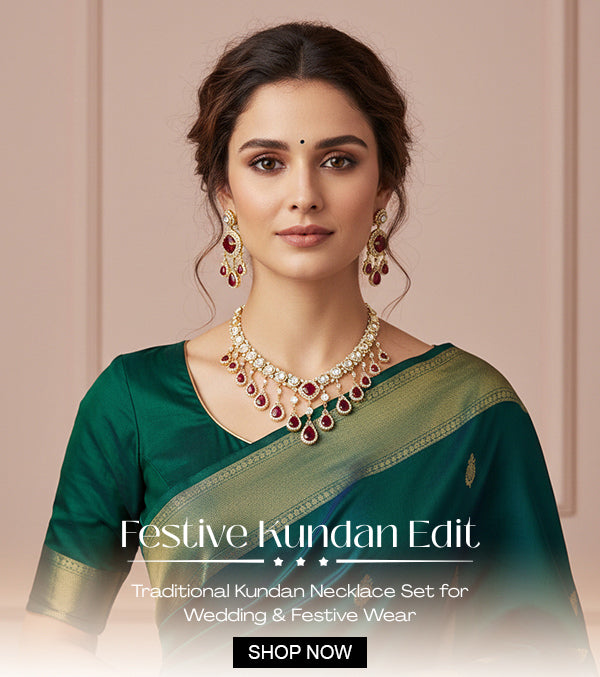 Woman wearing a traditional Kundan necklace set with a green saree on a beige background