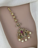 Decorative belly button ring with pearls and gemstones on a model's belly button.