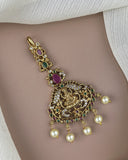 Decorative gold belly button ring with pearls and gemstones on a neutral background